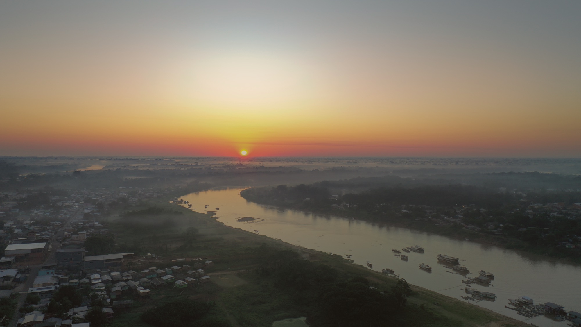 Dawn over Cruzeiro do Sul and the river, seen from above through the mist